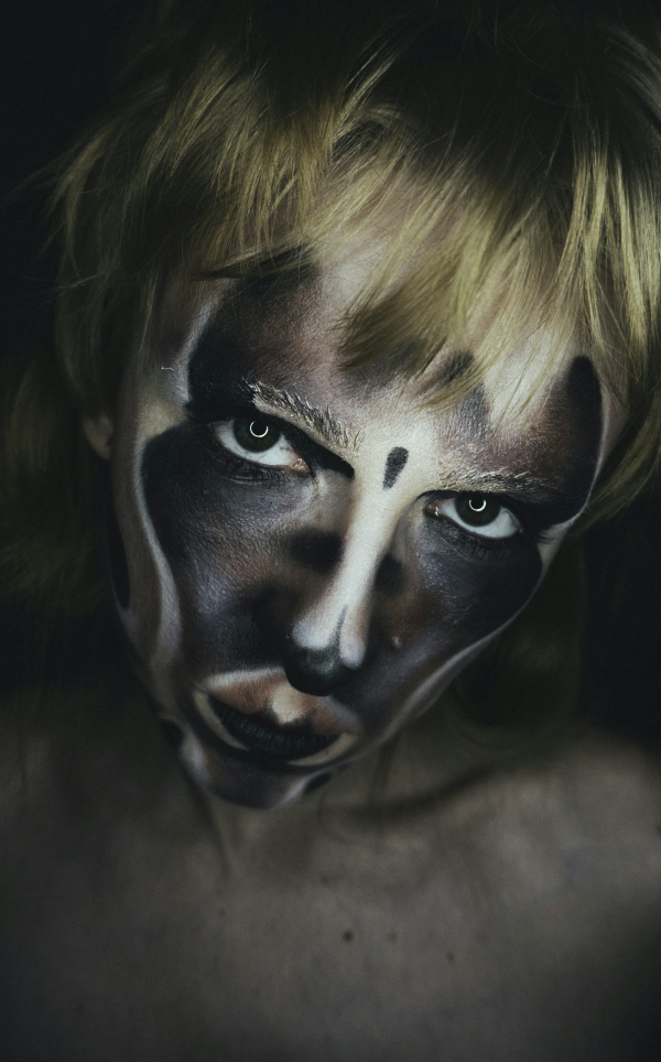 A woman with a face painted like a clown