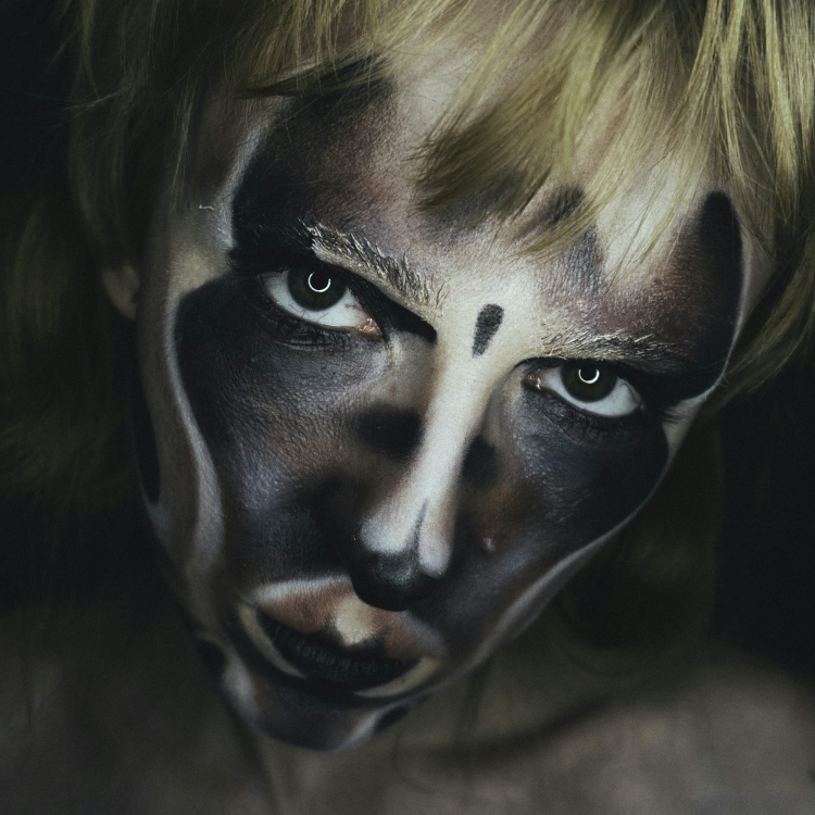 A woman with a face painted like a clown