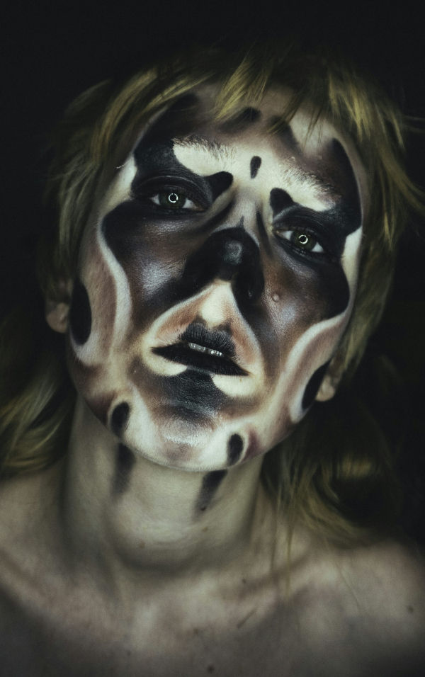 A woman with black and white makeup on her face