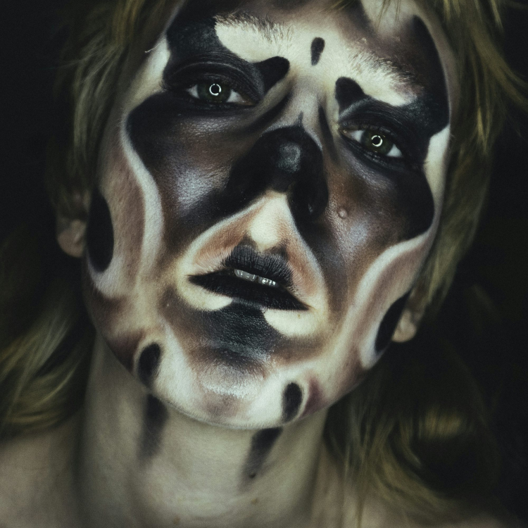 A woman with black and white makeup on her face