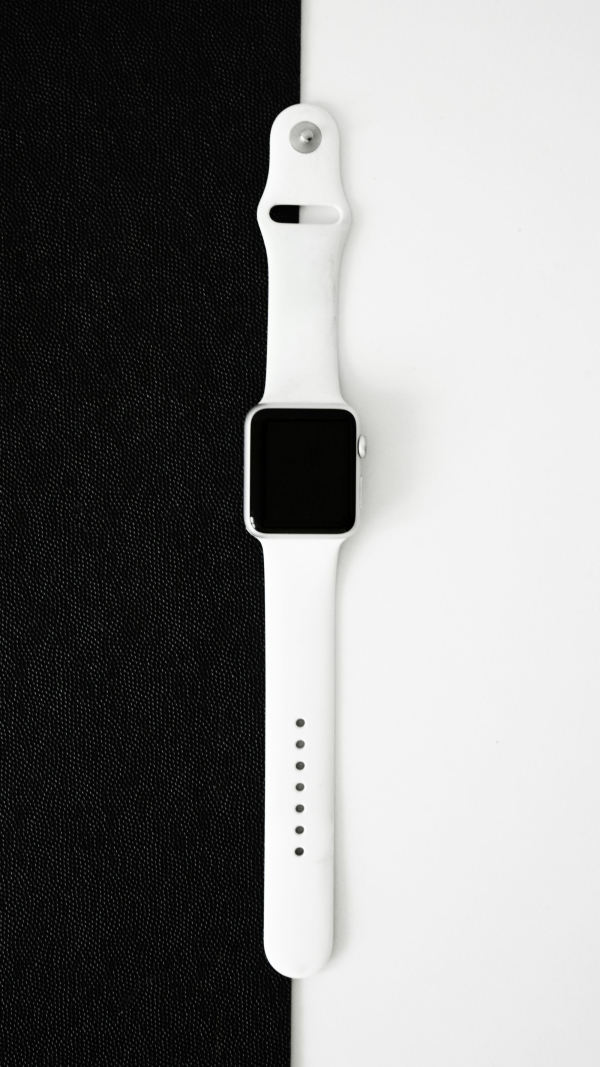 An apple watch sitting on top of a black cloth