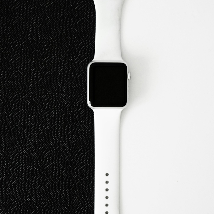 An apple watch sitting on top of a black cloth