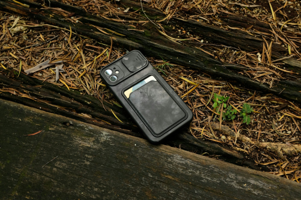 An old cell phone laying on the ground