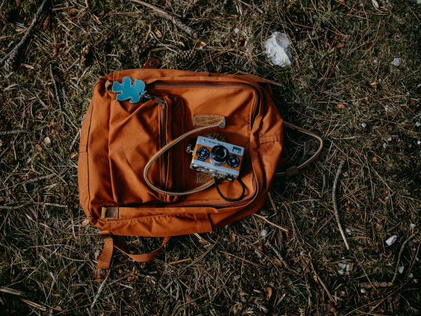 Brown and blue backpack on ground