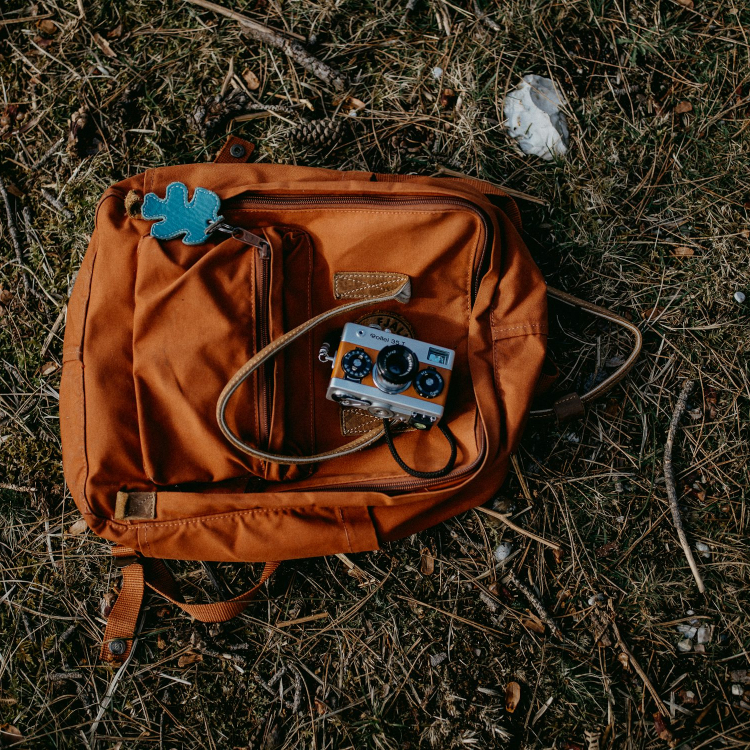 Brown and blue backpack on ground