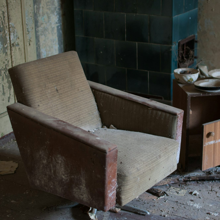 Brown fabric armchair beside side table