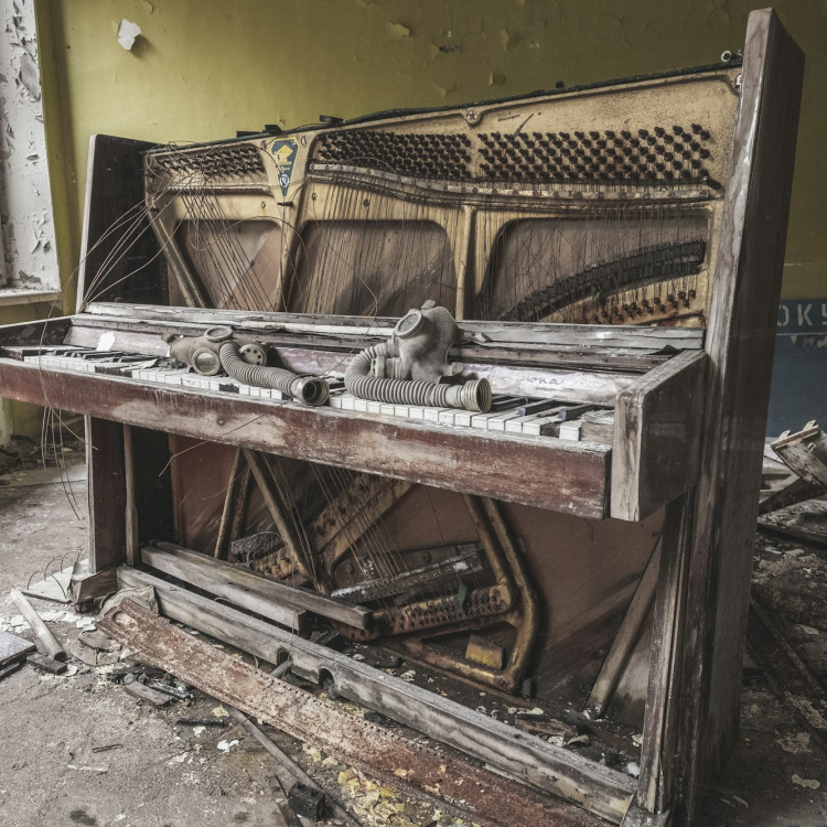 Brown wooden piano near yellow painted wall
