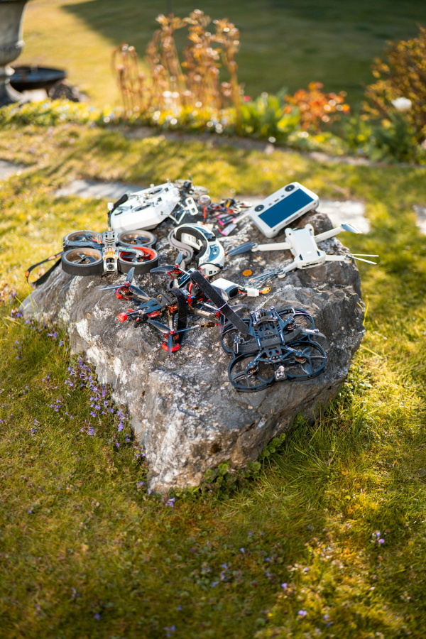 Drones and accessories on a stone outside