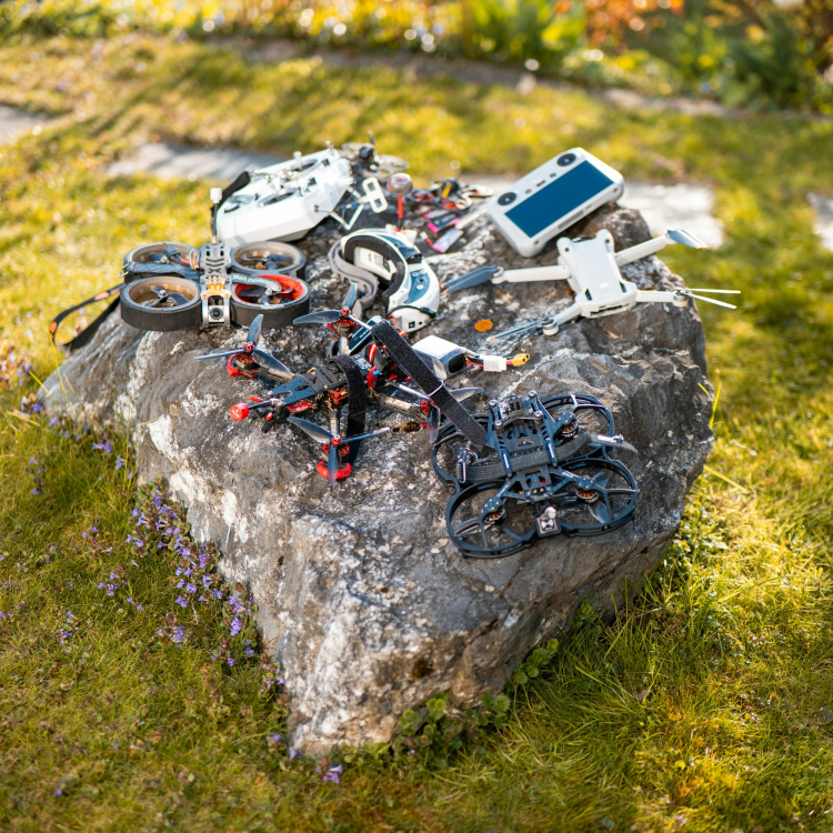 Drones and accessories on a stone outside