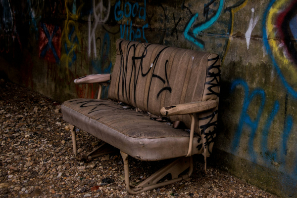 Empty brown leather sofa near wall