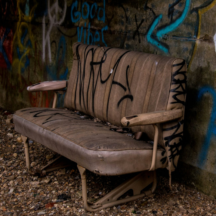 Empty brown leather sofa near wall