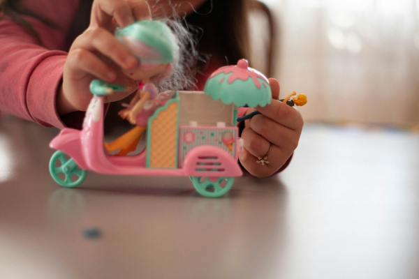 Girl holding pink and white plastic toy