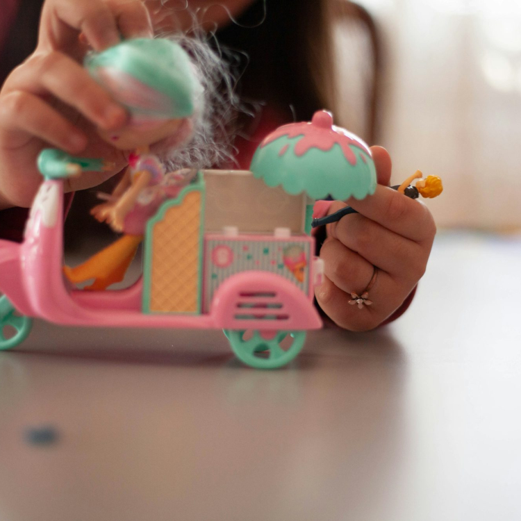 Girl holding pink and white plastic toy