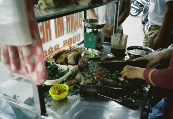 Person holding knife slicing meat