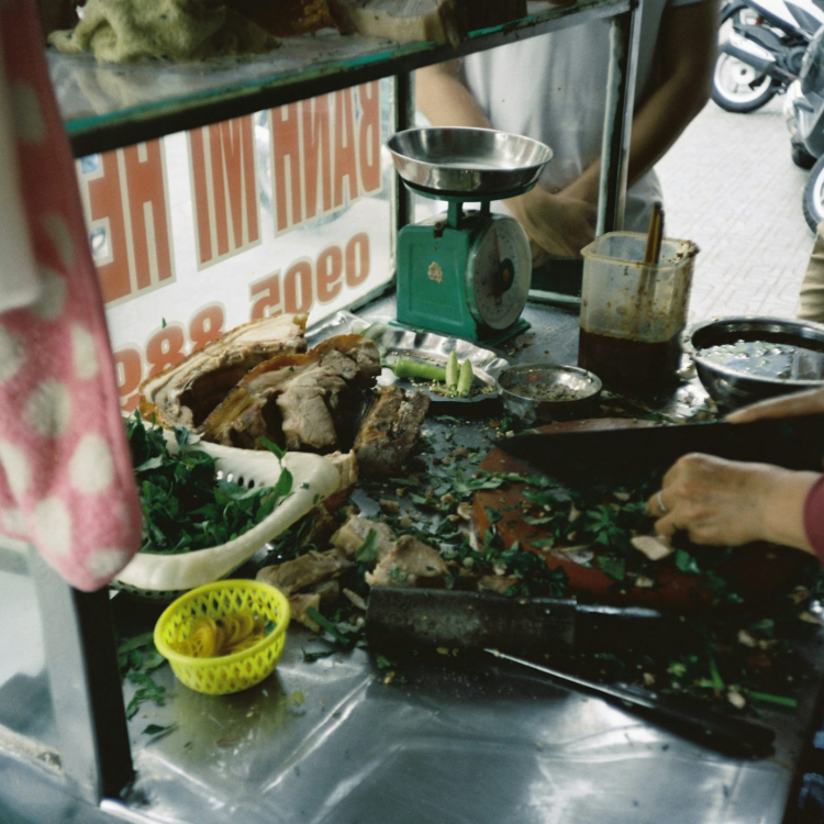 Person holding knife slicing meat
