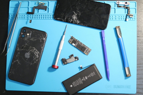 Phone parts scattered on a repair mat