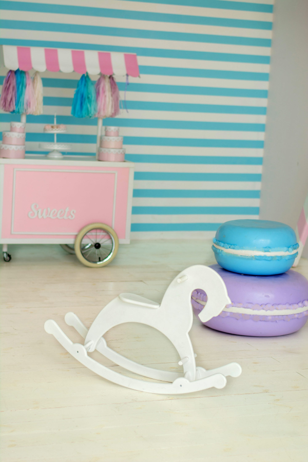 Pink and white wooden rocking horse