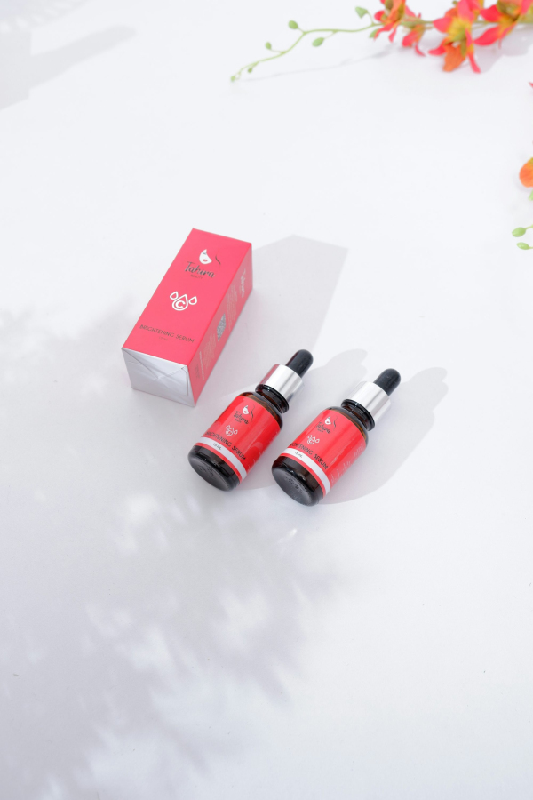 Red and black bottles on white surface