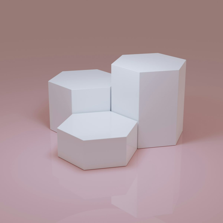 Three white boxes sitting on top of a pink surface