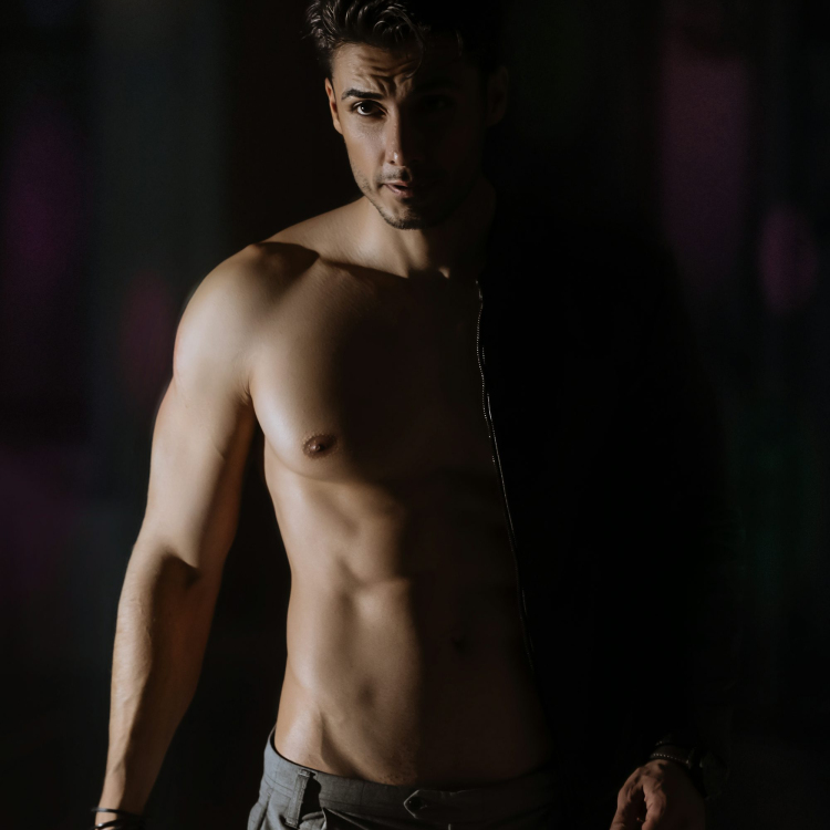 Topless man in black and white shorts