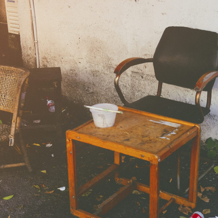 Two chairs and a table in front of a wall