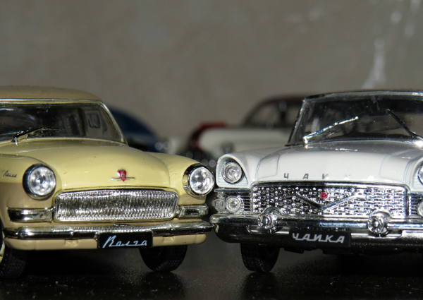 Two white and yellow die cast model toy cars