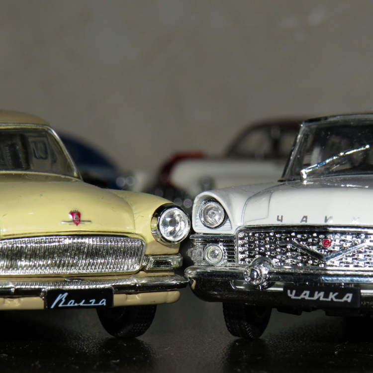 Two white and yellow die cast model toy cars