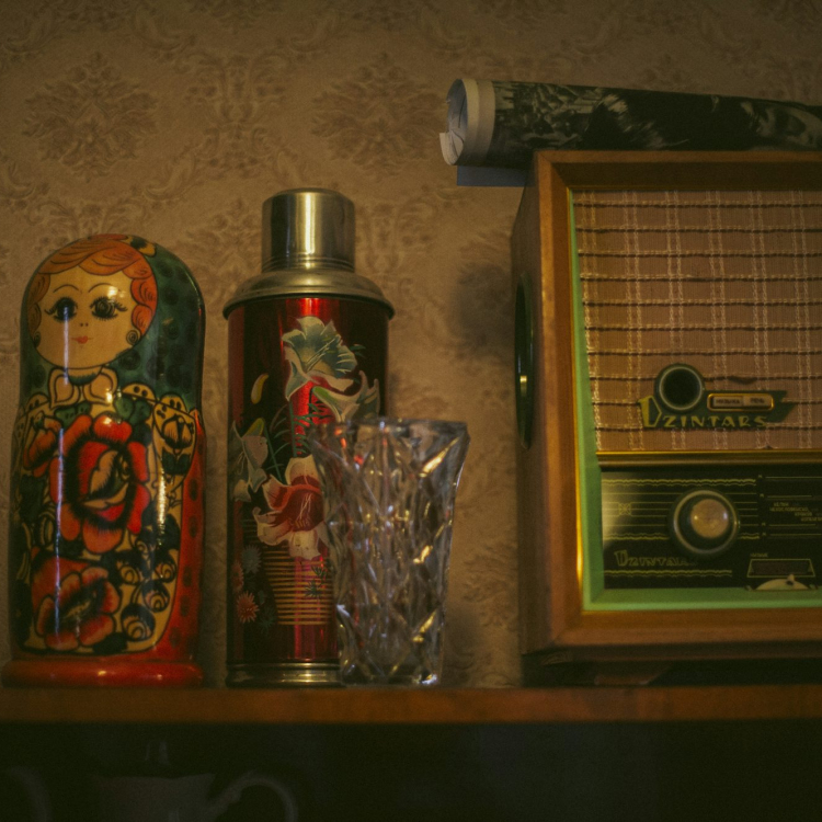 Vintage shelf decor includes a matryoshka doll