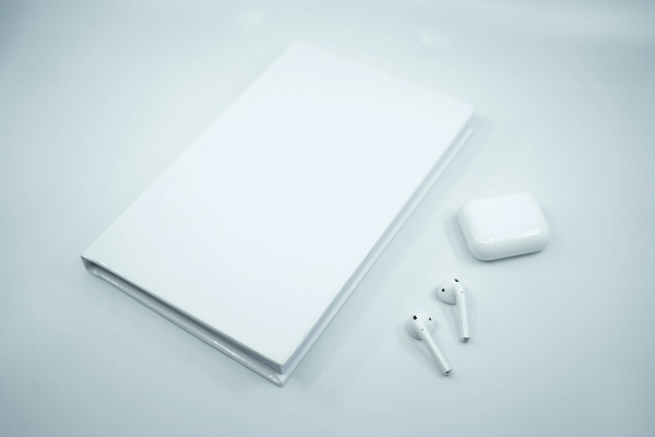 White apple earpods on white surface
