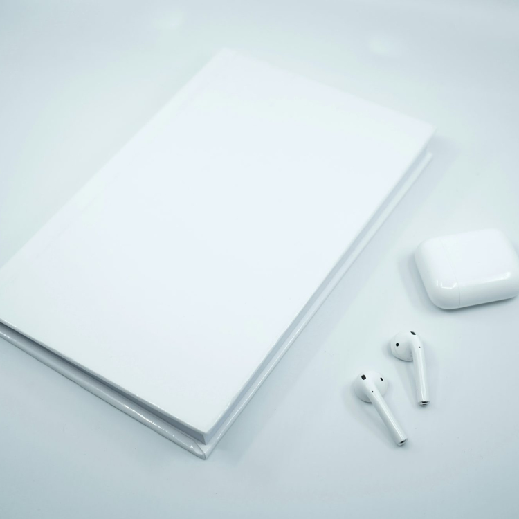 White apple earpods on white surface