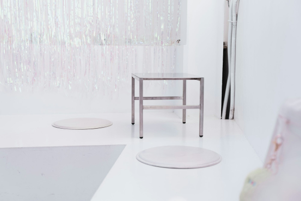 White round table near white floral curtain