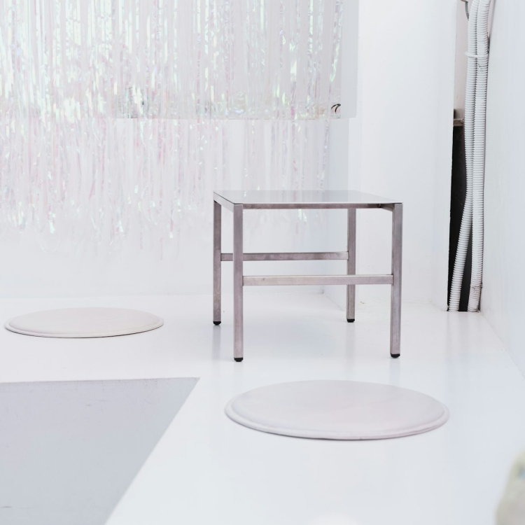 White round table near white floral curtain
