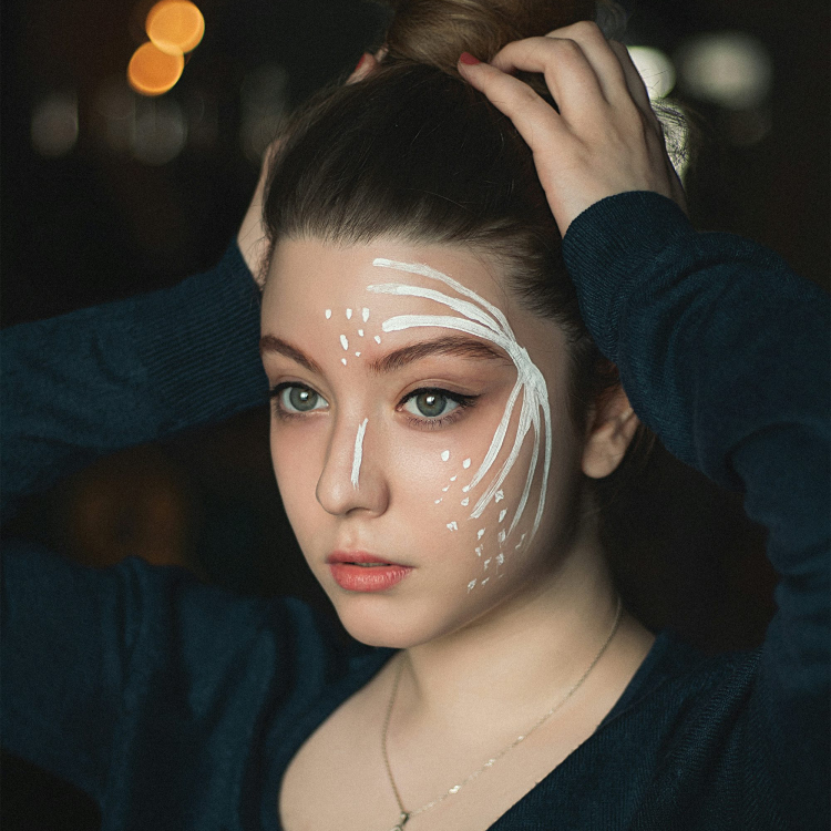 Woman in black v neck long sleeve shirt with white face mask