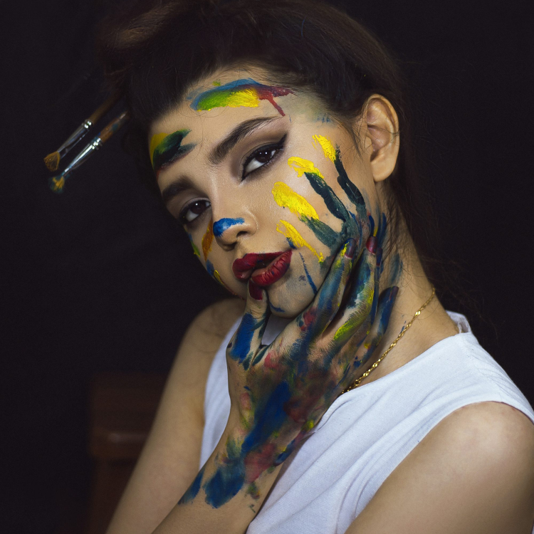 Woman in white tank top with red and black face paint
