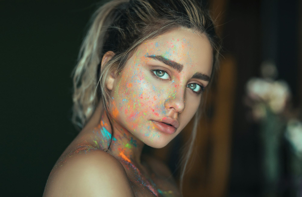 Woman with multicolored face paint