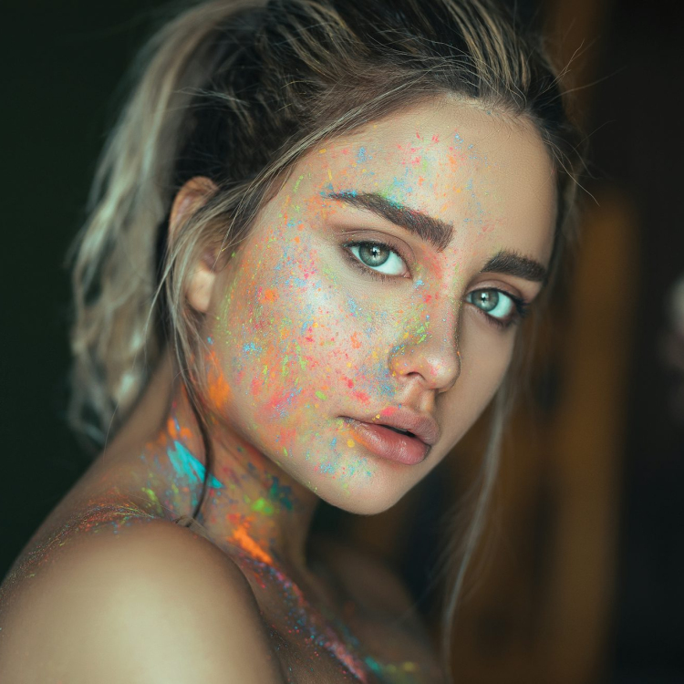 Woman with multicolored face paint